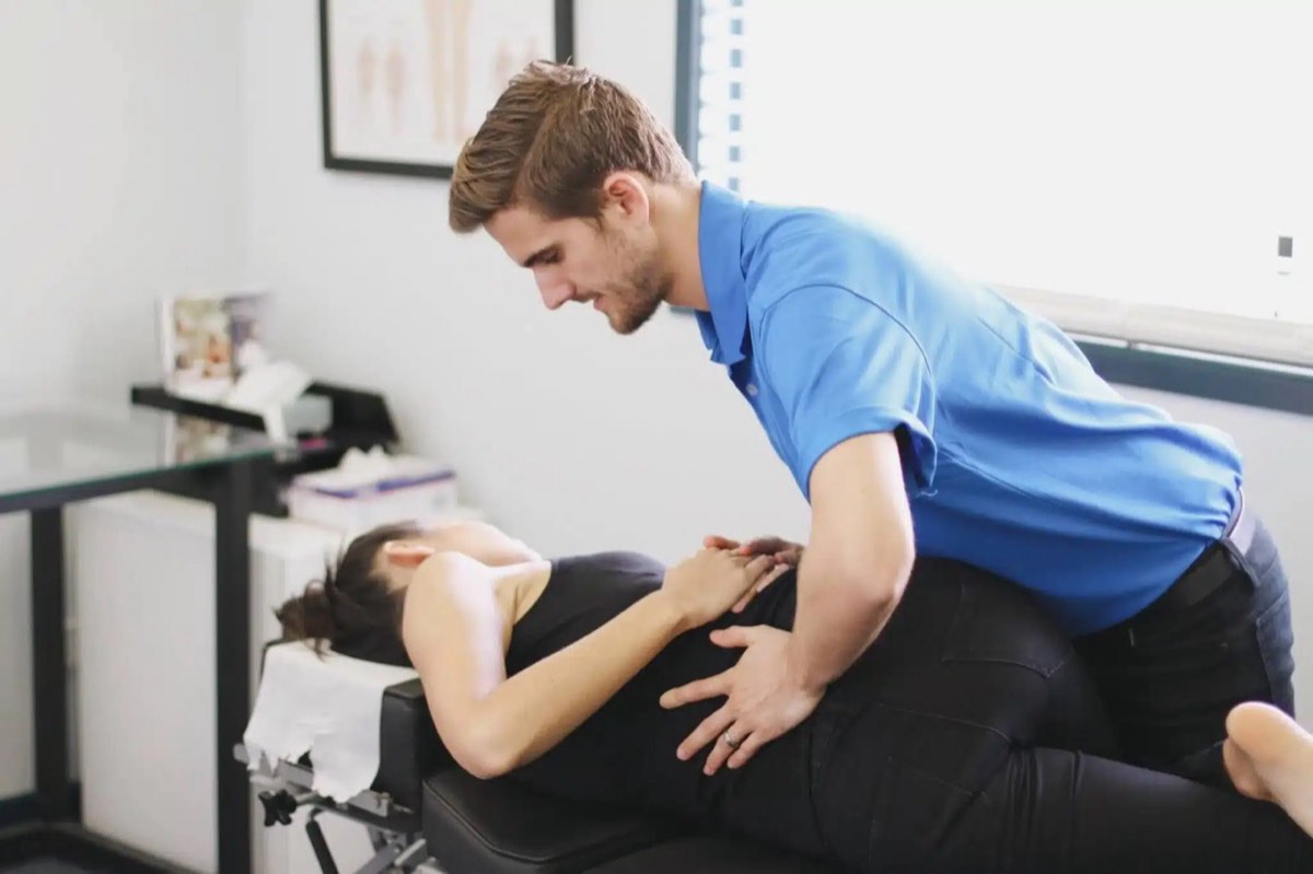 Chiropractor adjusting patient's back for pain management on the Sunshine Coast.