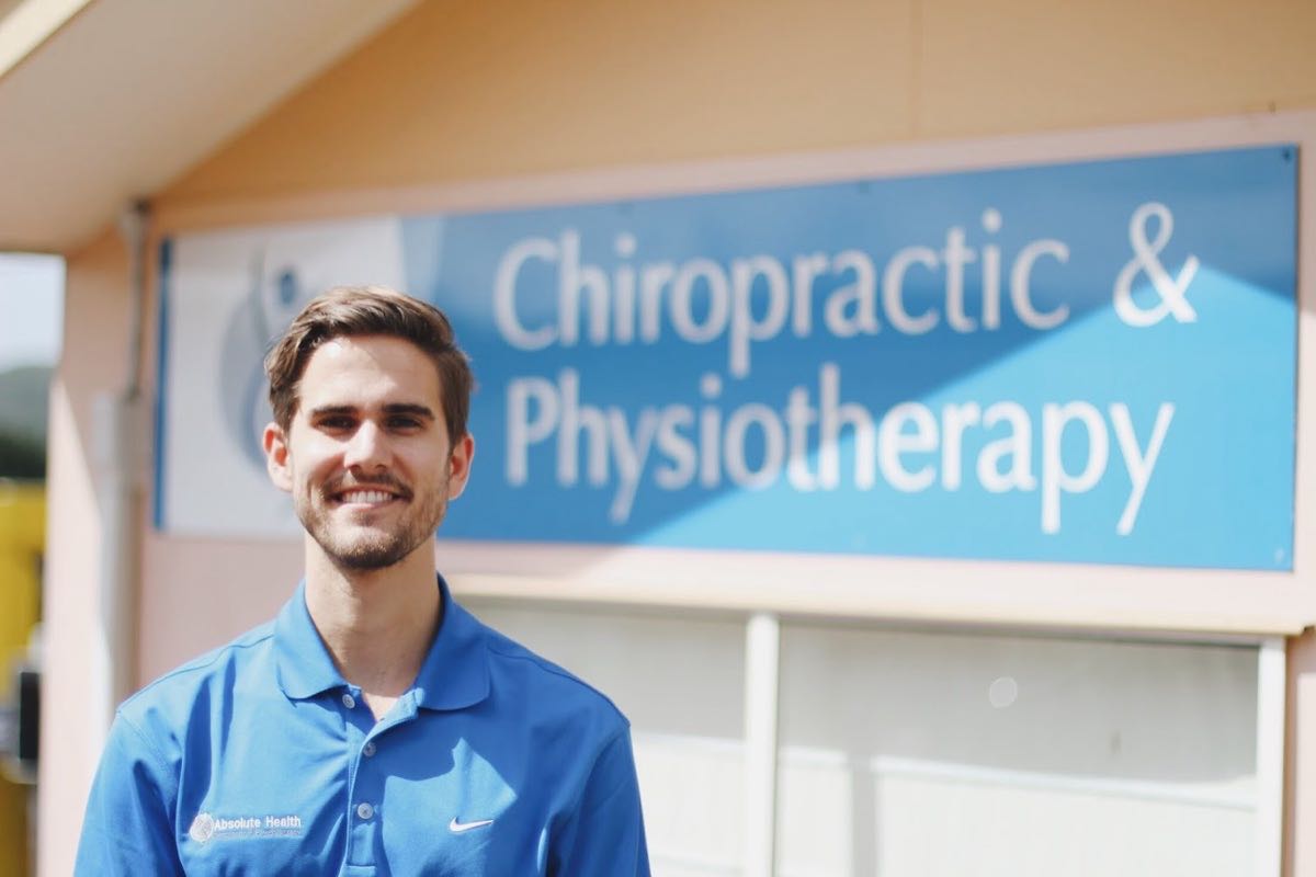 Absolute Health Nambour clinic exterior with chiropractic and physiotherapy signage and practitioner.