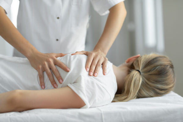 Woman Having Chiropractic Back Adjustment